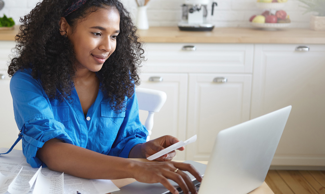 Woman paying bills after a personal injury settlement
