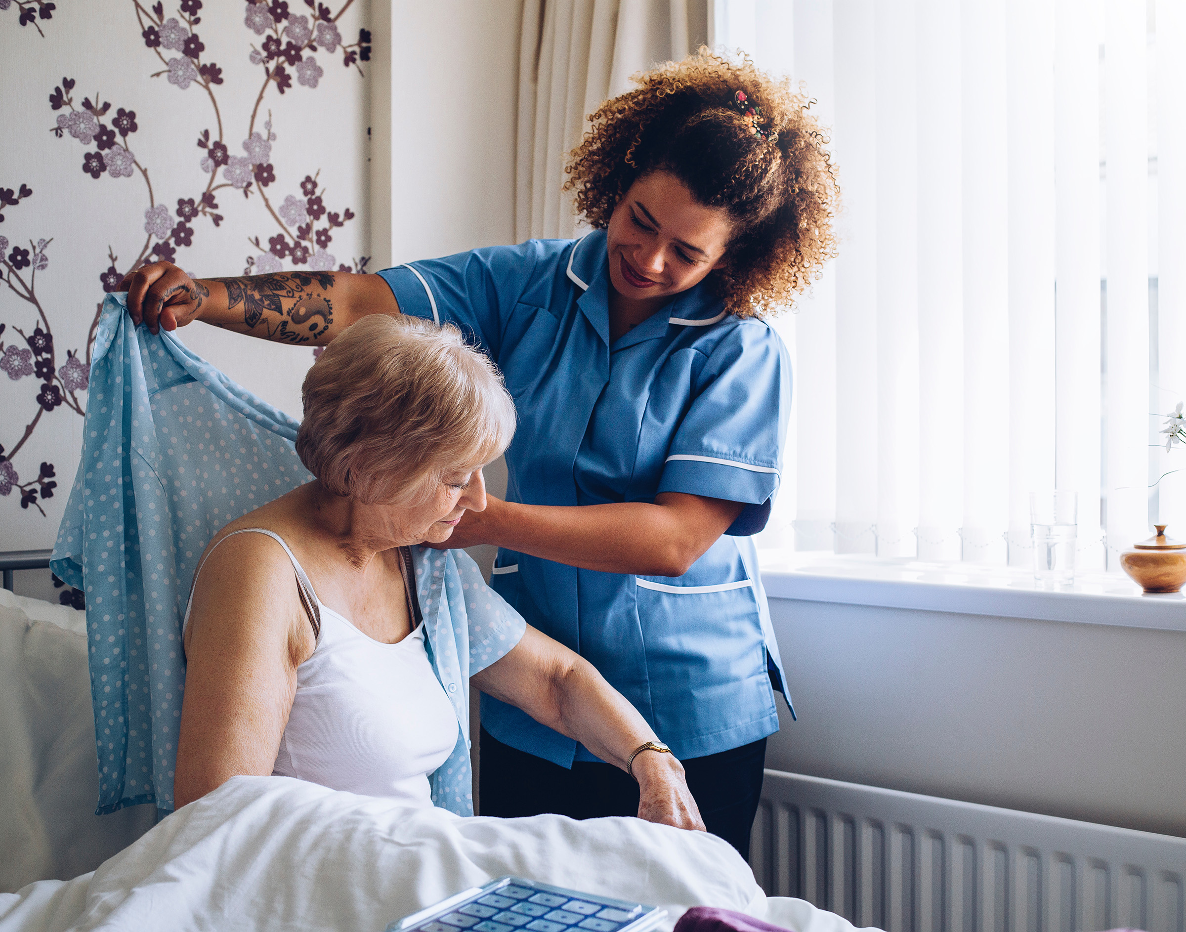 Nursing home attendant assisting a senior resident
