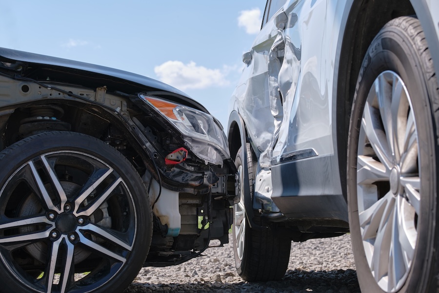 Two cars damaged after a collision on a city street