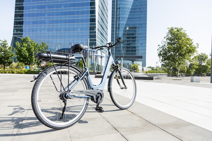 electric bicycle in front of office towers