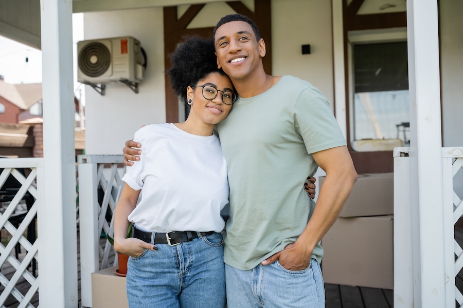 A couple outside their home