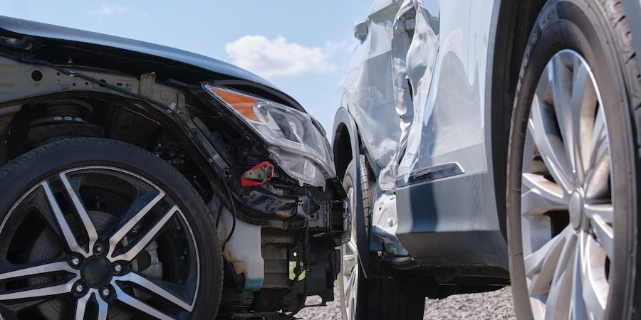 Two cars damaged after a collision on a city street