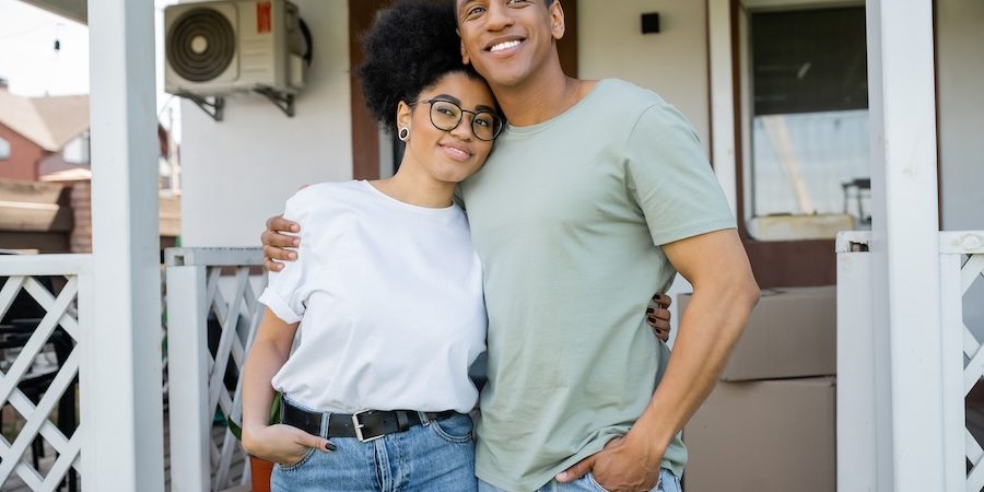 A couple outside their home